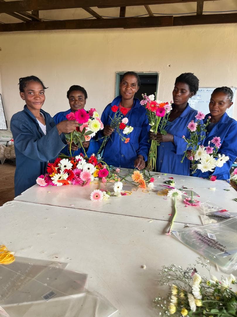 Team members practising bouquet-making with fresh-cut flowers